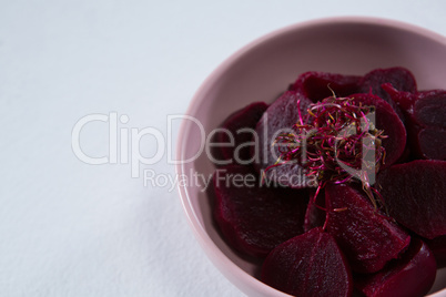 Slices of beetroots in a bowl on white background