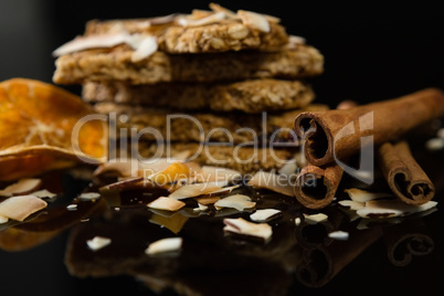 Granola bars with dried coconut, cinnamon sticks and orange slices