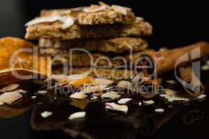 Granola bars with dried coconut, cinnamon sticks and orange slices