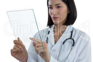 Female doctor using a glass digital tablet