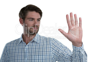 Man gesturing stop sign against white background