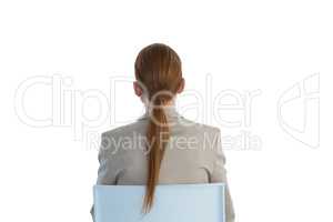 Rear view of businesswoman with redhead sitting on chair