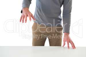 Mid section of businessman gesturing at table