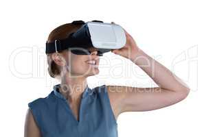 Happy young businesswoman wearing virtual reality glasses