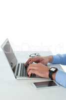 Cropped image of businessman using laptop computer at table