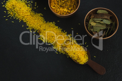 Various spices in bowl with yellow rice