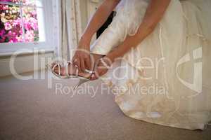Low section of bride in weding dress wearing sandals