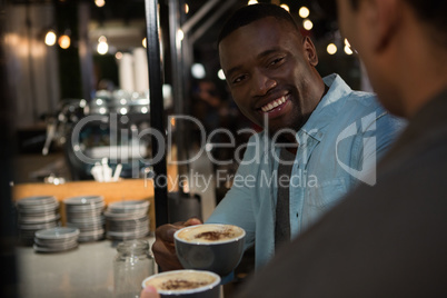 Happy man interacting while having coffee Happy man interacting while having coffee