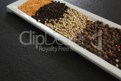 Various spices and seeds in tray