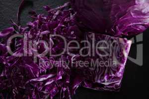 Chopped red cabbage on black background