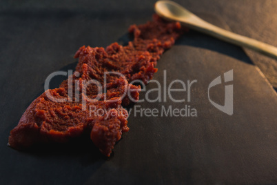 Red chili chutney on wooden board