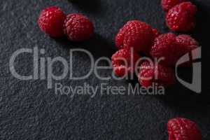 Raspberries on black background