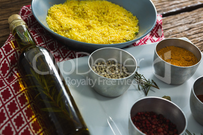 Rice in bowl with various spices ingredients