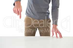 Mid section of creative businessman gesturing while standing at table