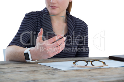 Mid section of businesswoman using glass interface
