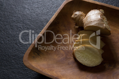 Sliced ginger on wooden tray