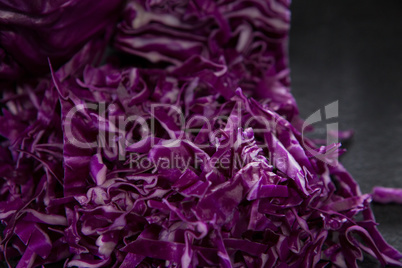 Chopped red cabbage on black background