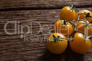 Yellow tomatoes on wooden table