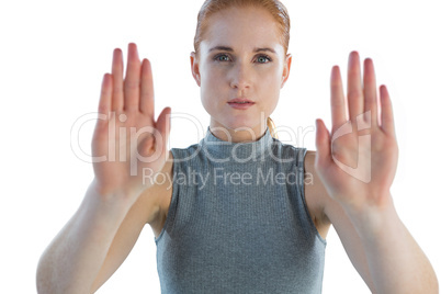 Portrait of serious businesswoman showing stop gesture
