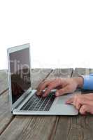 Cropped image of hands using laptop