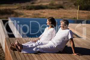 Couple relaxing on wooden plank