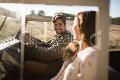 Young couple interacting while travelling in vehicle
