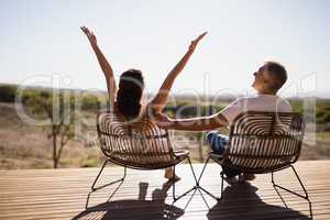 Senior couple sitting on chairs at the resort