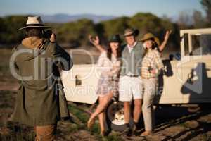 Man taking a picture of his friends during safari vacation