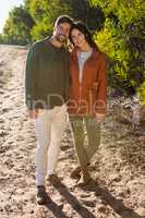 Portrait of couple standing on field