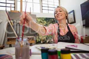 Woman selecting a paintbrush