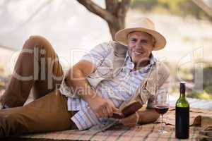 Portrait of happy man reading book in cottage