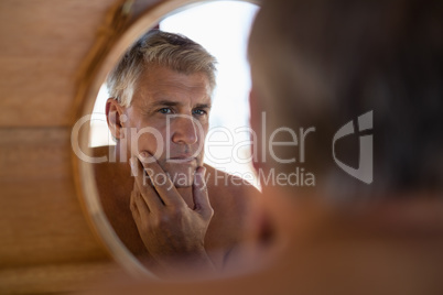 Man looking at mirror in cottage