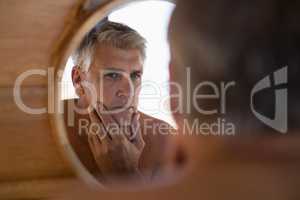 Man looking at mirror in cottage