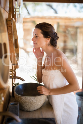 Woman looking at mirror in cottage