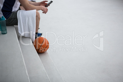 Basketball player using mobile phone