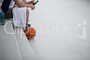 Basketball player using mobile phone