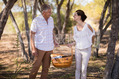 Smiling couple holding a wicker basket