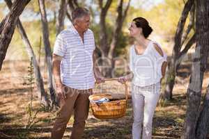 Smiling couple holding a wicker basket