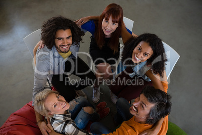 High angle portrait of adult students huddling