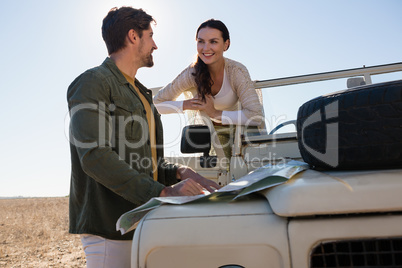 Smiling couple looking each other at forest