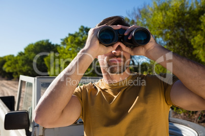 Man looking through binocular