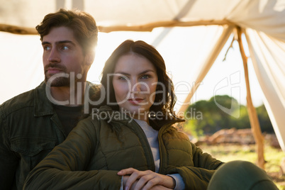Portrait of woman with man in tent