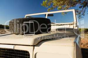 Tablet and spare tire on vehicle hood