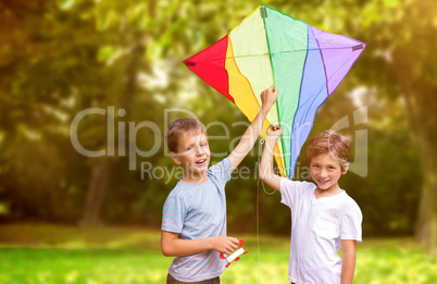 Composite image of portrait of boys with colorful kite