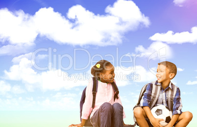 Composite image of boy with friend holding soccer ball