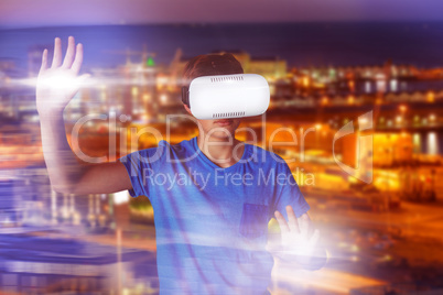 Composite image of boy using virtual reality simulator