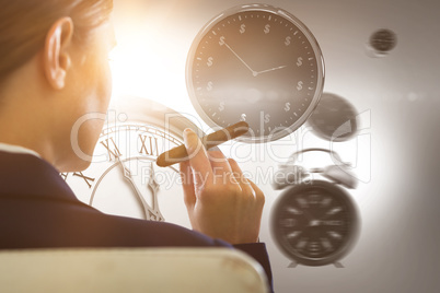 Composite image of businesswoman holding cigar