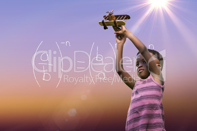 Composite image of boy holding toy airplane