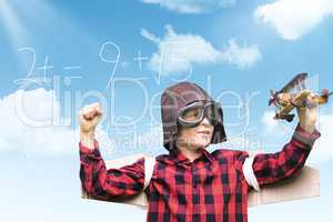 Composite image of boy in aviator cap holding toy airplane