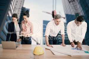 Composite image of architects working at table